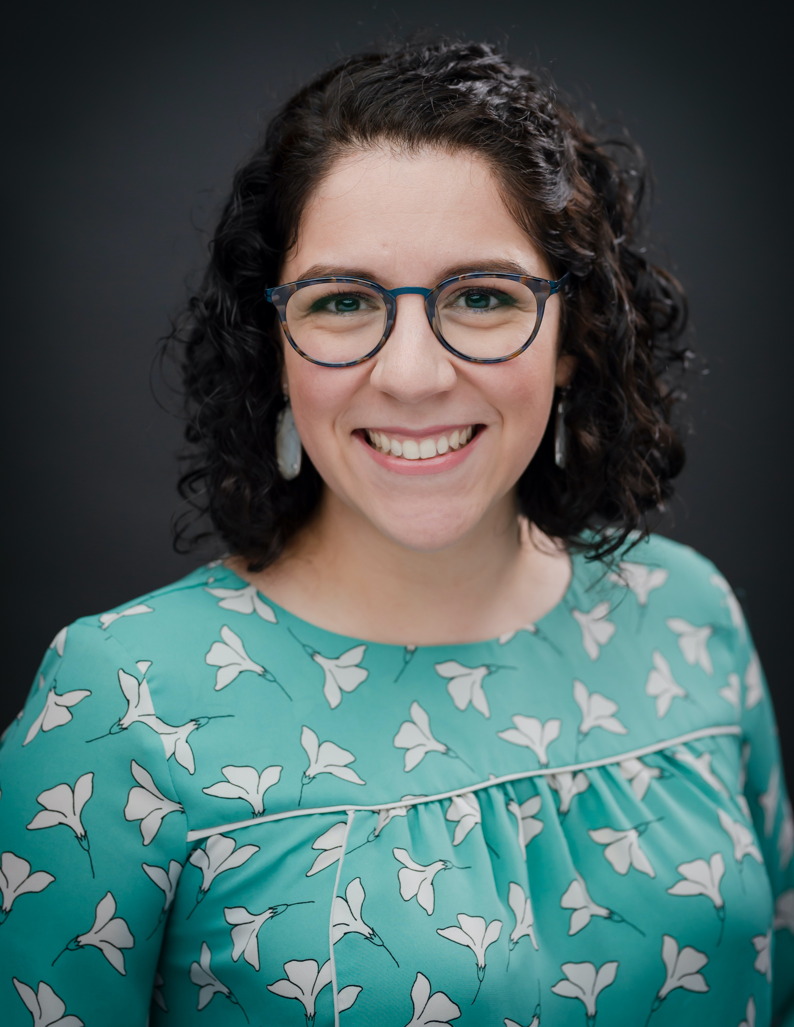 A female smiling at the camera.